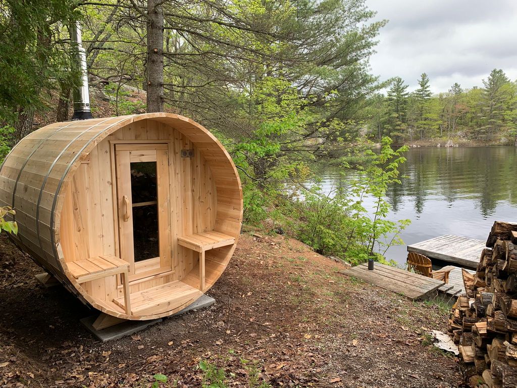 Canadian cedar barrel sauna beside a lake